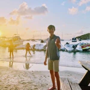 little boy carrying a shell in the BVI chartering the caribbean islands