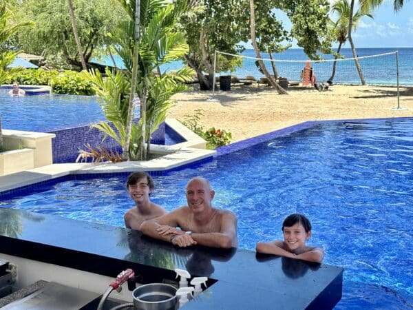 yacht chartering family at the beach in a pool playing Antigua