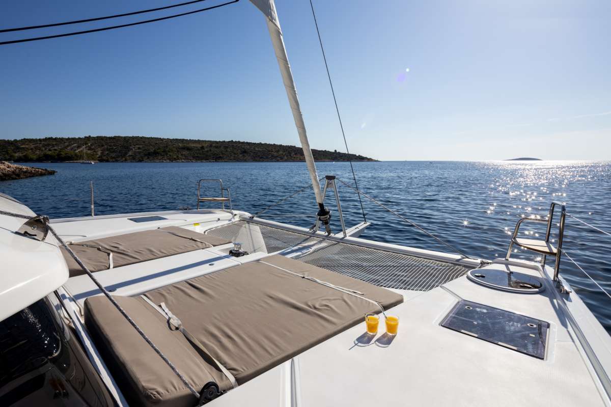 Luxury BVI catamaran charter deck view near Cooper Island with calm turquoise water aboard Aquanimity